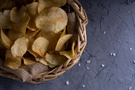natural potato chips on a gray concrete backgroundの写真素材