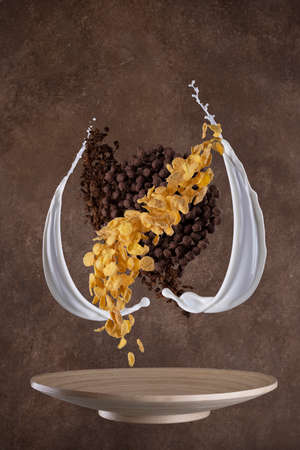 splashes of milk, cornflakes and granola. Levitation on brown backround