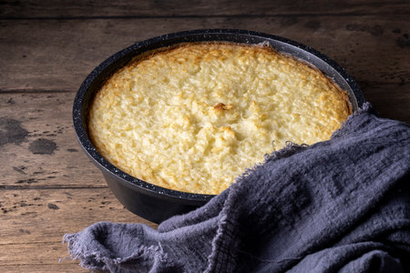 Baking dish with tasty rice casserole on wooden background.の写真素材