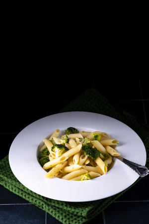 pasta with broccoli on a black background.の写真素材