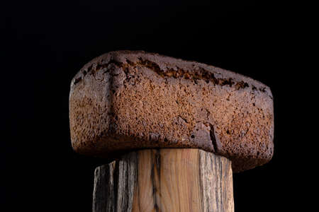 loaf of rye homemade bread in dark background.