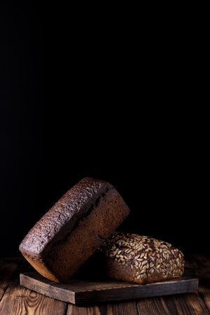 handmade bread over a wood with black background.