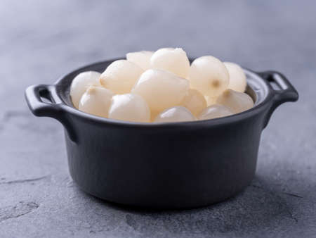 Marinated onion in the black bowl on gray backgroundの写真素材