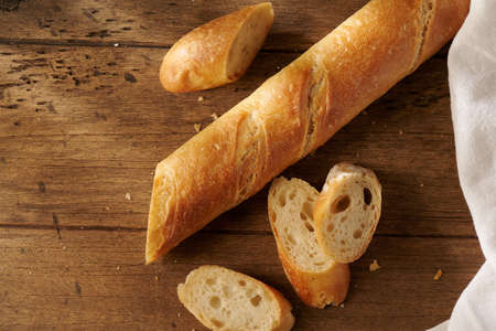 fresh homemade baguette on a wooden background