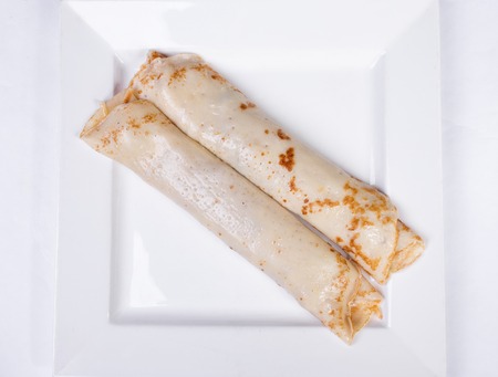 pancakes stuffed with meat and mushrooms on a white backgroundの写真素材