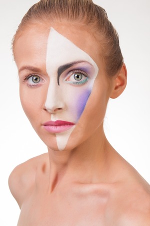 Portrait of a young girl with paint on his face. White background