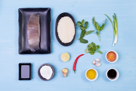 Food ingredients and kitchen utensils for cooking on wooden background.の写真素材