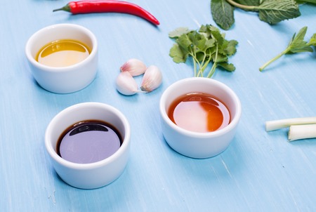 Food ingredients and kitchen utensils for cooking on wooden background.の写真素材