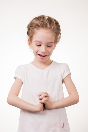 Portrait of surprised excited girl covering her mouth by the hand. Isolated on white background.の写真素材