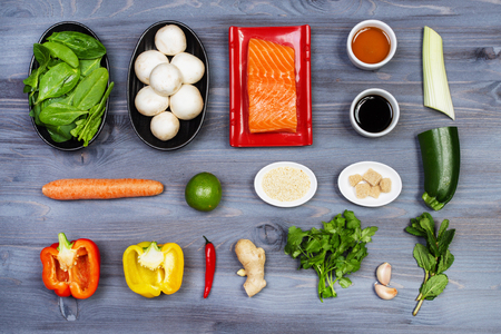 Wooden spoon and ingredients on dark background. Vegetarian food, health or cooking concept.の写真素材