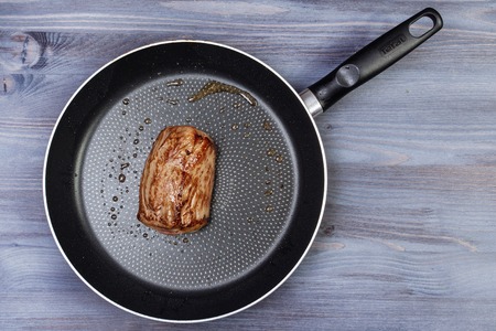 Ingredients for cooking and empty cutting board on an old wooden table. Food background with...