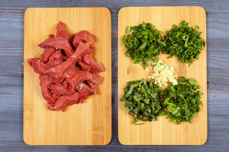 Wooden spoon and ingredients on dark background. Vegetarian food, health or cooking conceptの写真素材