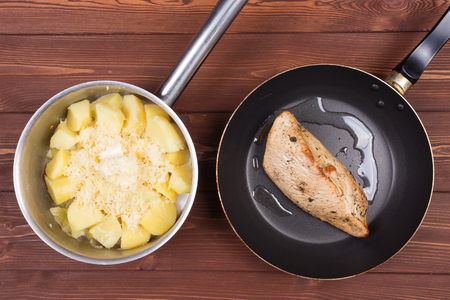 Ingredients for cooking and empty cutting board on an old wooden table. Food background with copyspaceの写真素材