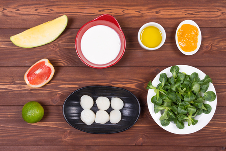 Wooden spoon and ingredients on dark background. Vegetarian food, health or cooking concept.の写真素材