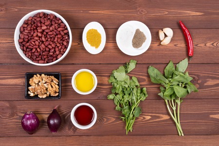 Wooden spoon and ingredients on dark background. Vegetarian food, health or cooking concept.の写真素材