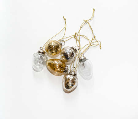 Golden and silver Christmas ornaments isolated on a white background.の写真素材