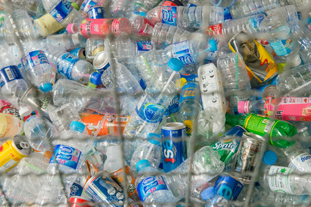PHAYATHAI, BANGKOK - OCTOBER 3, 2015: Collection of plastic bottles and cans in a steel cage awaiting to be recycled.のeditorial素材