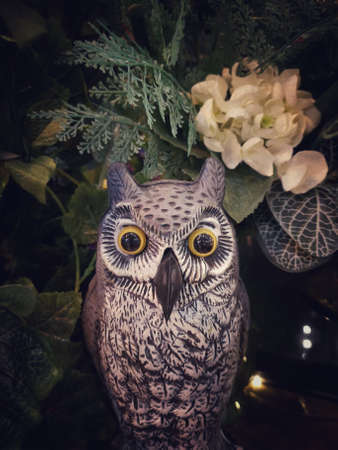 Halloween scene : Cute owl figure sculpture made from paper mache decorated with multi flower and tree branchの写真素材