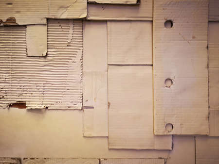 Background and Different texture of the old corrugated cardboard on the wall. Layer of brown packing and recycle paper. Scrap and patch of corrugated paperboard with copy spaceの写真素材