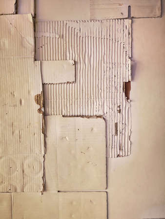 Background and Different texture of the old corrugated cardboard on the wall. Layer of brown packing and recycle paper. Scrap and patch of corrugated paperboard with copy spaceの写真素材