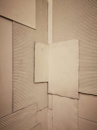 Background and Different texture of the old corrugated cardboard on the wall with corner and perspective. Layer of brown packing and recycle paper. Scrap and patch of corrugated paperboard, copy spaceの写真素材