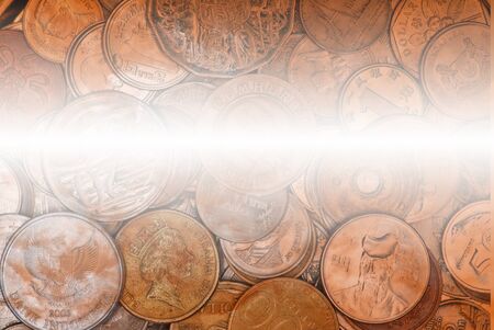 Coins currency from multiple countries in a golden round case with sky/cloud overlay, taken from top...