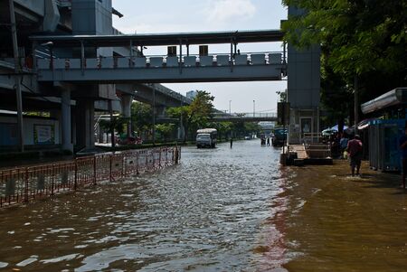 BANGKOK - NOVEMBER 7 2011:Large bus carried flood victims after impact with heaviest flood and rain in 20 years in the capital on November 07, 2011 in Bangkok, Thailand.のeditorial素材