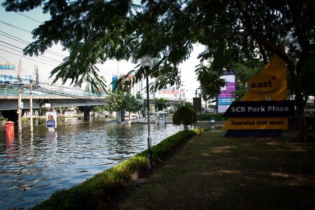 BANGKOK - NOVEMBER 7 2011: Front of Siam Commercial Bank headquarter building after impact with heaviest flood and rain in 20 years in the capital on November 07, 2011 in Bangkok, Thailand.のeditorial素材