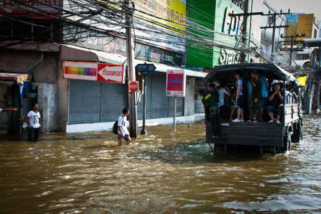 BANGKOK - NOVEMBER 7 2011: Unidentified group of victims are riding a truck after impact with heaviest flood and rain in 20 years in the capital on November 07, 2011 in Bangkok, Thailand. 
のeditorial素材