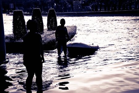 BANGKOK - NOVEMBER 7 2011: Unidentified children played in flood water after impact with heaviest flood and rain in 20 years in the capital on November 07, 2011 in Bangkok, Thailand.のeditorial素材