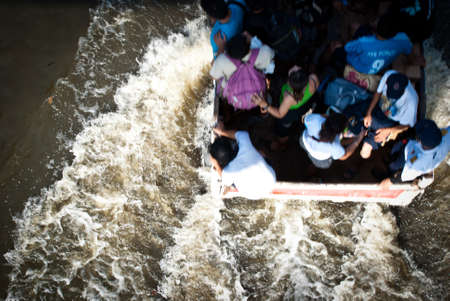 BANGKOK - NOVEMBER 7 2011: Unidentified group of victims are riding a truck after impact with heaviest flood and rain in 20 years in the capital on November 07, 2011 in Bangkok, Thailand. のeditorial素材