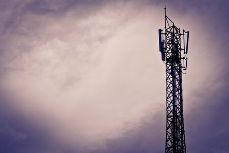 Mobile communication antenna taken on a cloudy day with silhouetteの写真素材