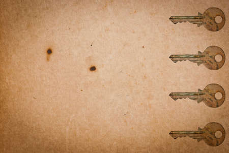 Rusty keys on old paper background with blended layers
の写真素材