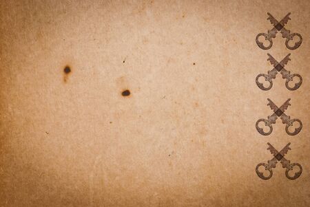 Rusty keys on old paper background with blended layers
の写真素材