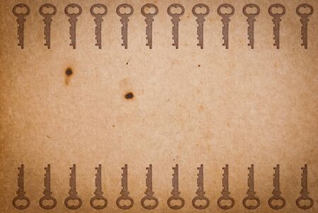 Rusty keys on old paper background with blended layers
の写真素材