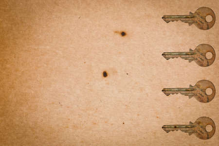 Rusty keys on old paper background with blended layers
の写真素材