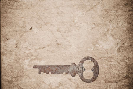 Rusty keys on old paper background with blended layersの写真素材