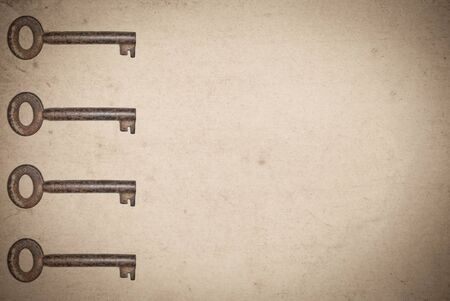 Rusty keys on old paper background with blended layers
の写真素材
