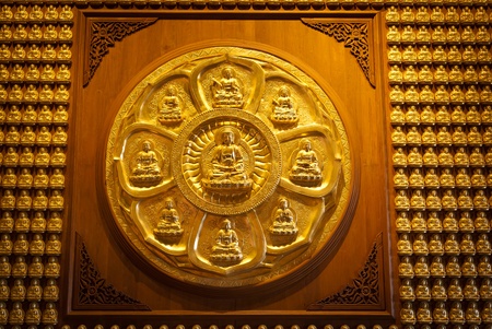 Golden chinese buddha statue on woodの写真素材