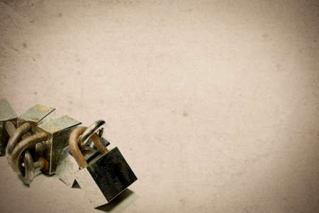 Rusty old aged padlocks on vintage paper background