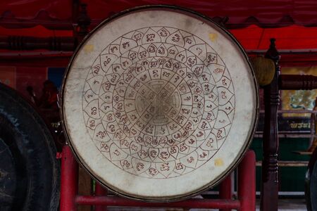 Asian wooden leather old temple drum with very old vintage talisman tattoo symbo on it,l