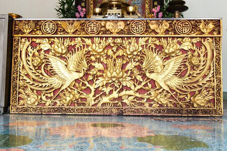 Ancient golden Chinese temple scuplture with symbolic patternのeditorial素材