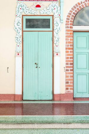 Chinese temple door with unique chinese pattern around it.の写真素材