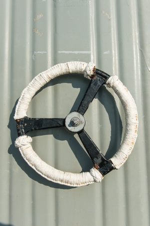 White metal door wheel, taken from battle ship water tight door handle, isolated in whiteの写真素材