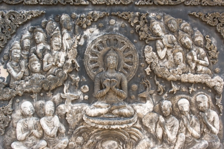 Ancient old vintage buddha sculpture on the wall, taken on a sunny dayの写真素材