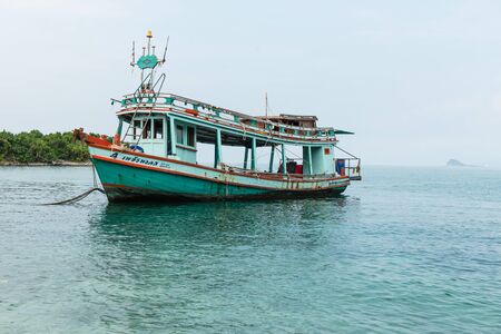 old small fishing boat on blue sea, taken on a sunny dayのeditorial素材