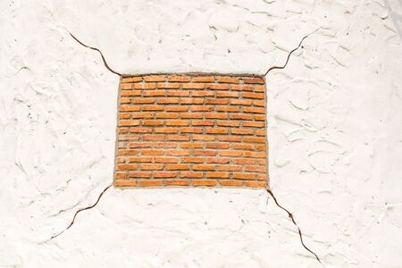Red square shape brick on white background with cracks, taken outdoor.の写真素材