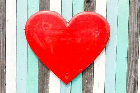 Blue, white, black contrasting old wooden texture background with heart shape, taken on a sunny dayの写真素材