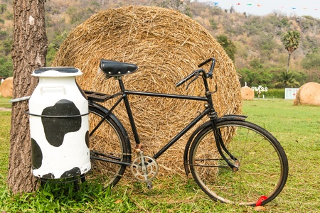 A black milk man bicycle with steel milk container at the back, taken outdoor on sunny dayの写真素材