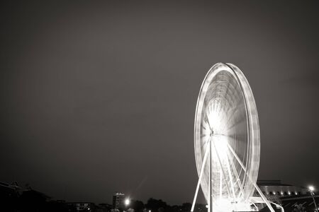 Fairy wheel in an amusement park during night time, taken at slow shutter.の写真素材